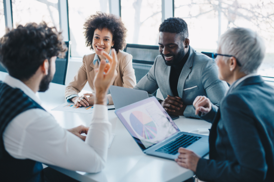 Diverse professionals sitting around a table at a meeting