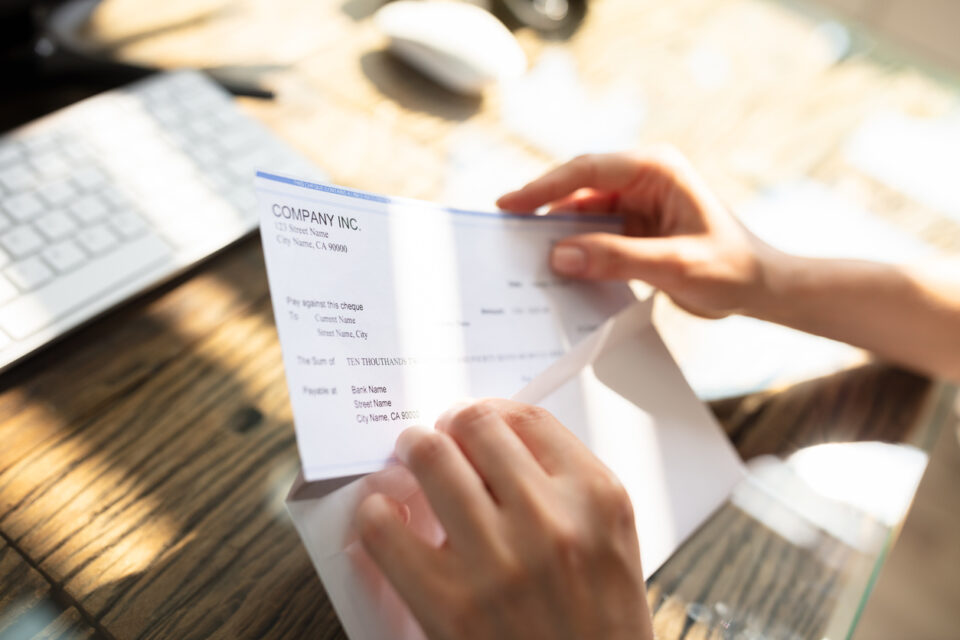 Employee opening a paycheck