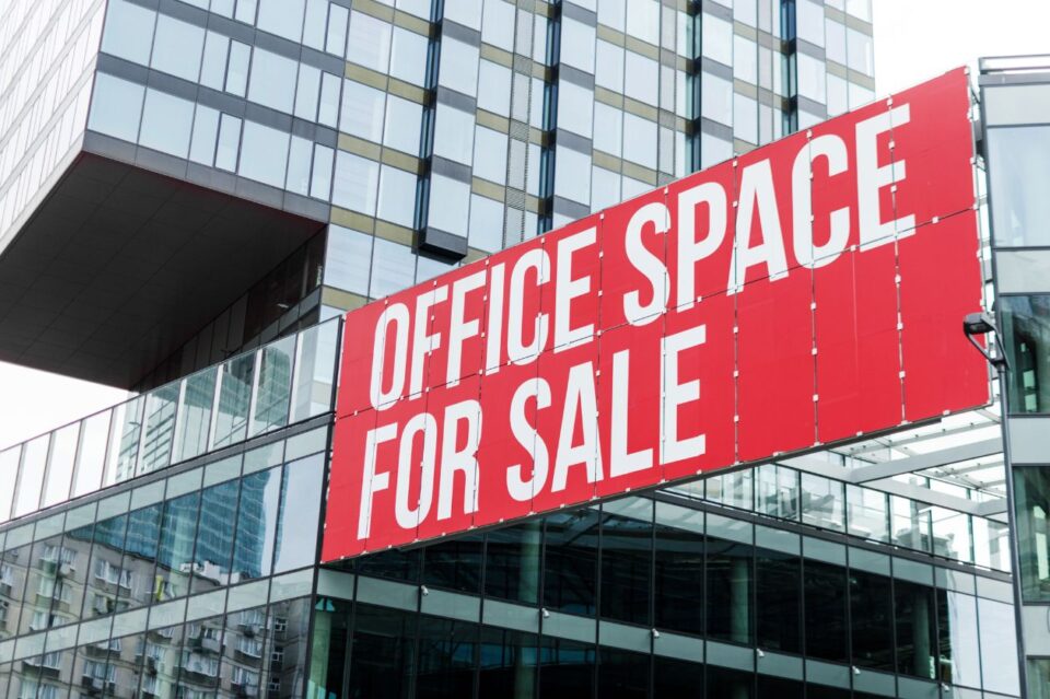 Office building with a red sign that reads "Office Space for Sale"