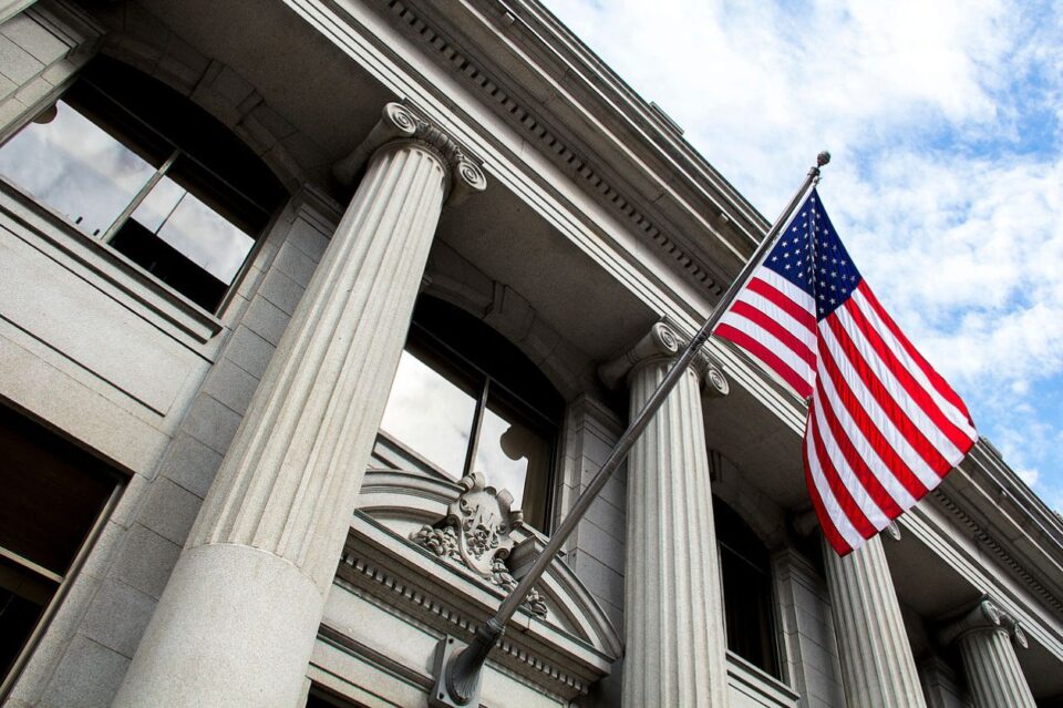 Federal courthouse with columns and an American Flag on a pole