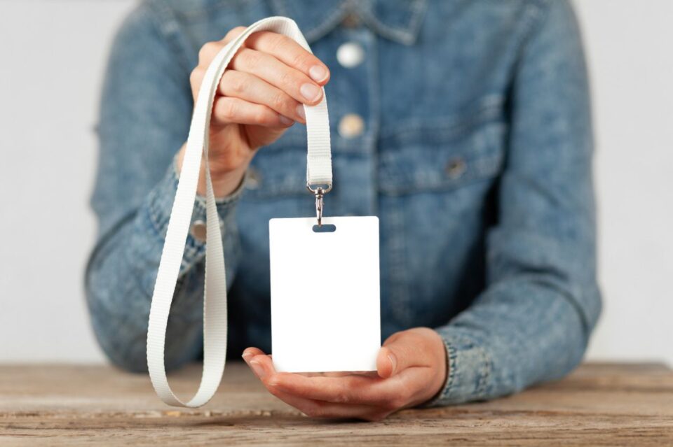 Name badge in hands.