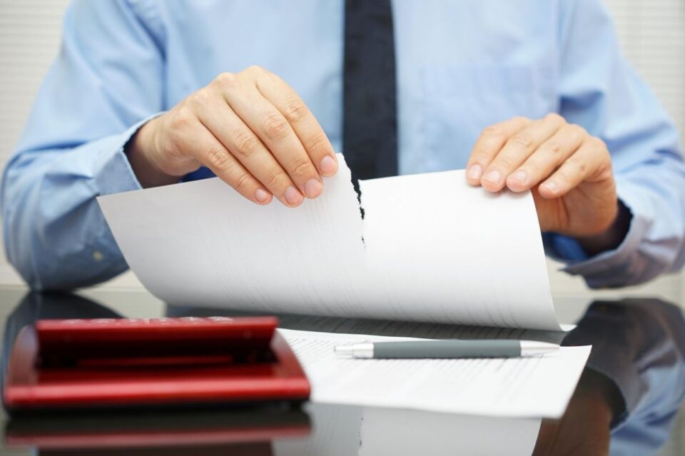 Businessman tears document in office stock photo