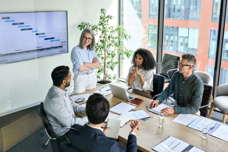 Diverse corporate team working together in modern meeting room office. stock photo