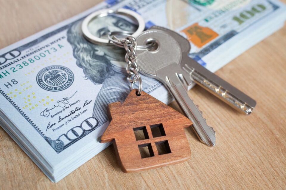 Real estate investing concept. American dollar, cash or housing. Keys close-up stock photo